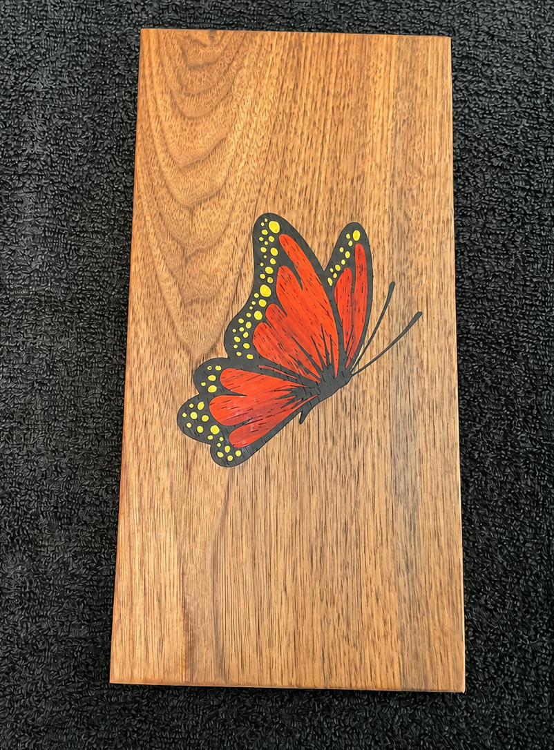 Finished butterfly wood inlay made from walnut, padauk, yellow heart, and wenge
