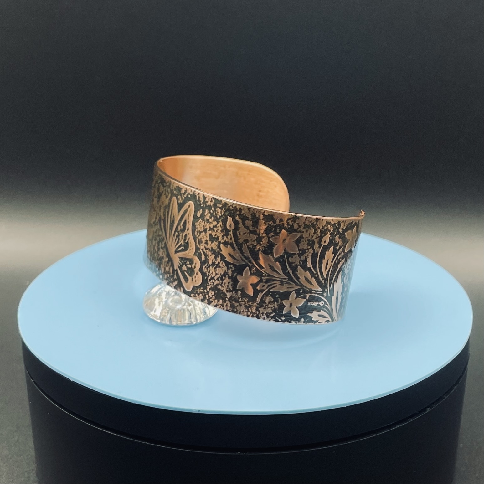 Embossed copper cuff bracelet with butterfly and floral pattern