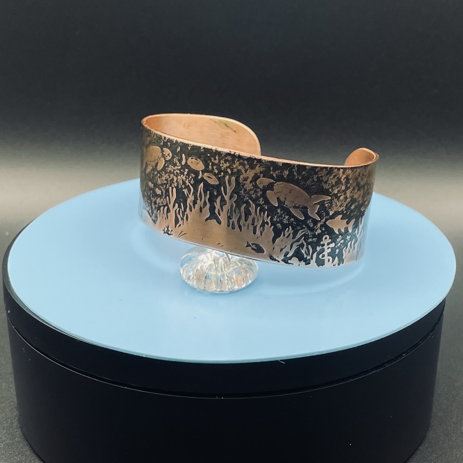 Embossed copper cuff bracelet with turtle and water pattern