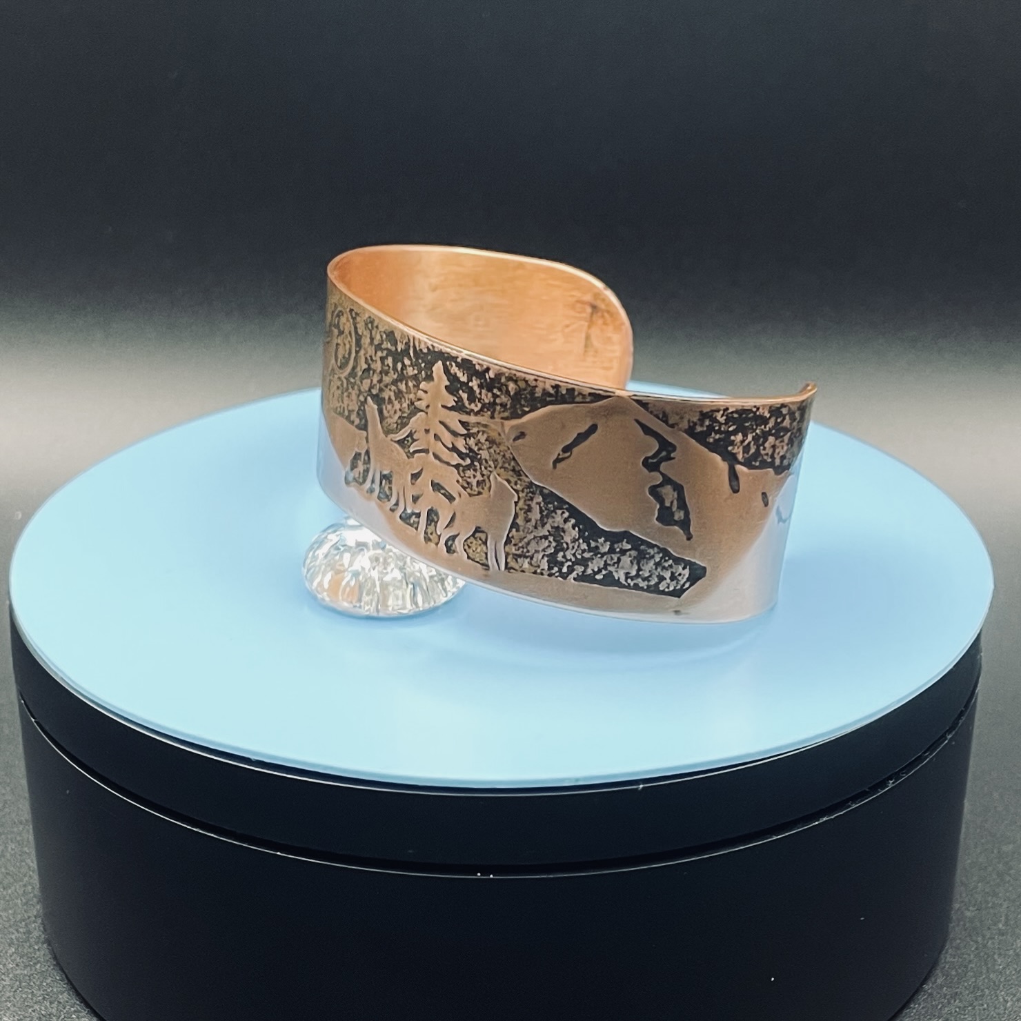 Embossed copper cuff bracelet with wolf scene