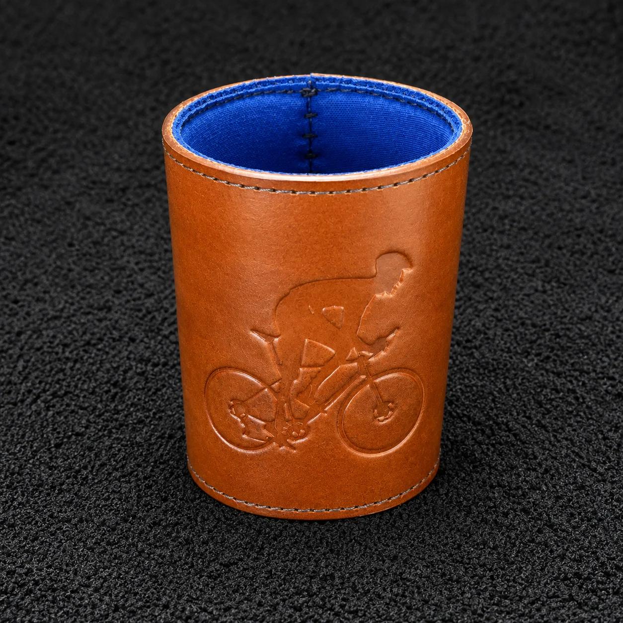 Tan leather drink koozie engraved with a road bike rider and blue lining
