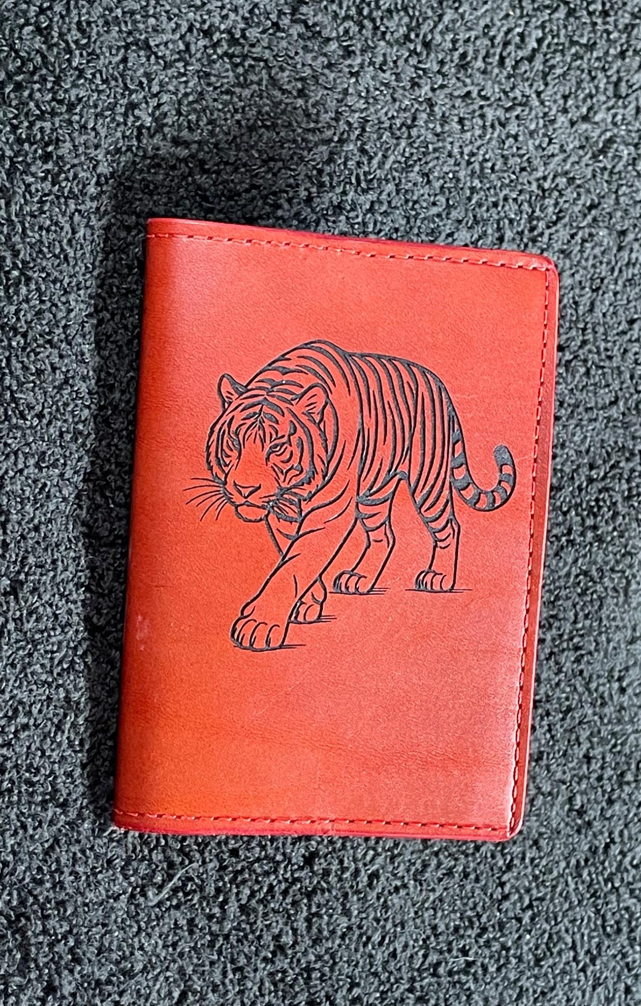 Small red leather notebook engraved with a tiger design