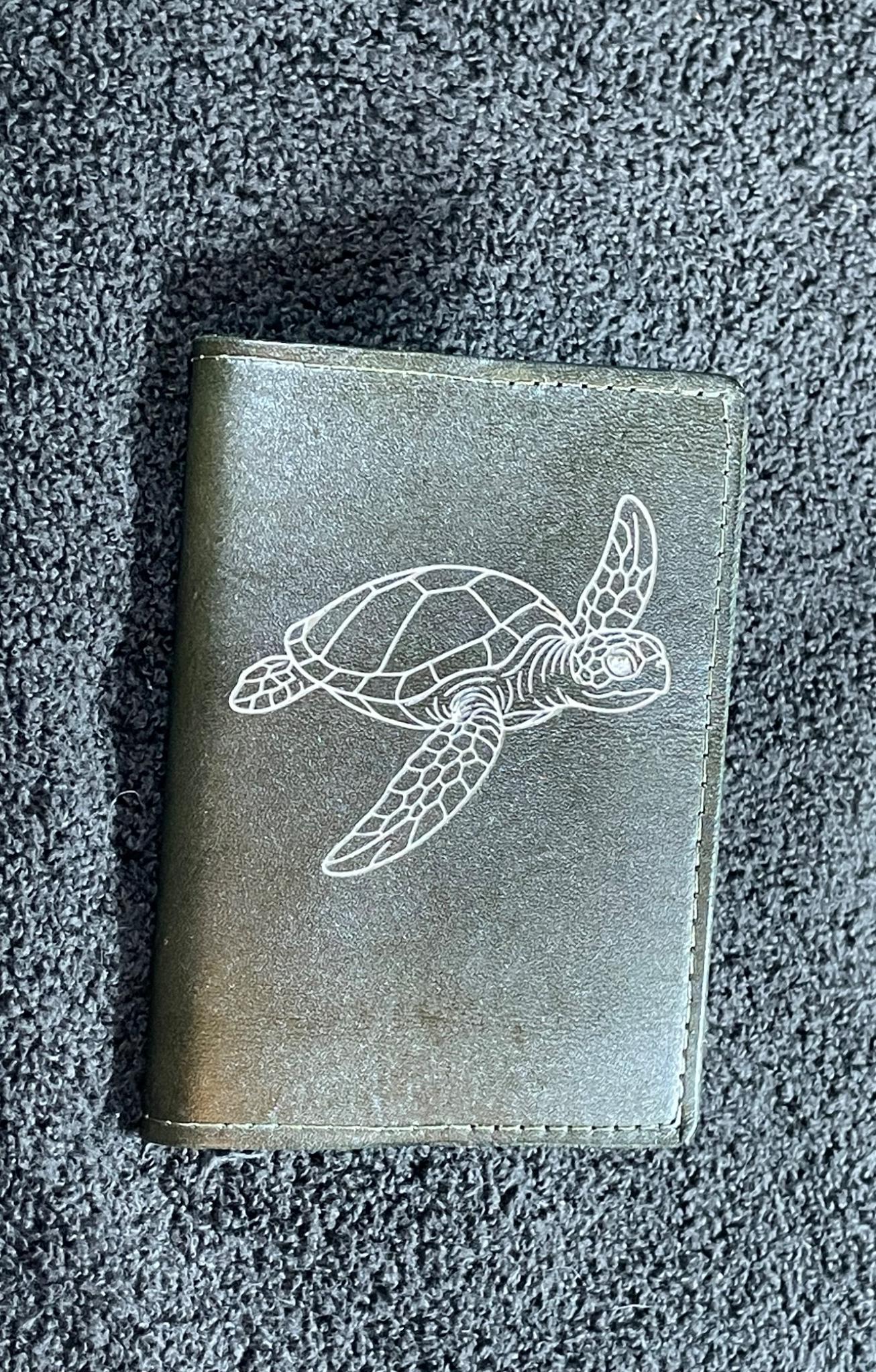 Small gray leather notebook engraved with a sea turtle design